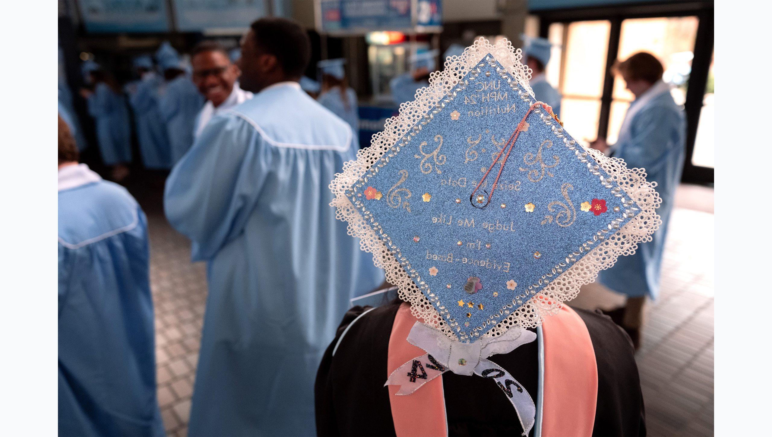 View of a graduate wearing a customized cap at U.N.C. Chapel Hill's Winter Commencement.