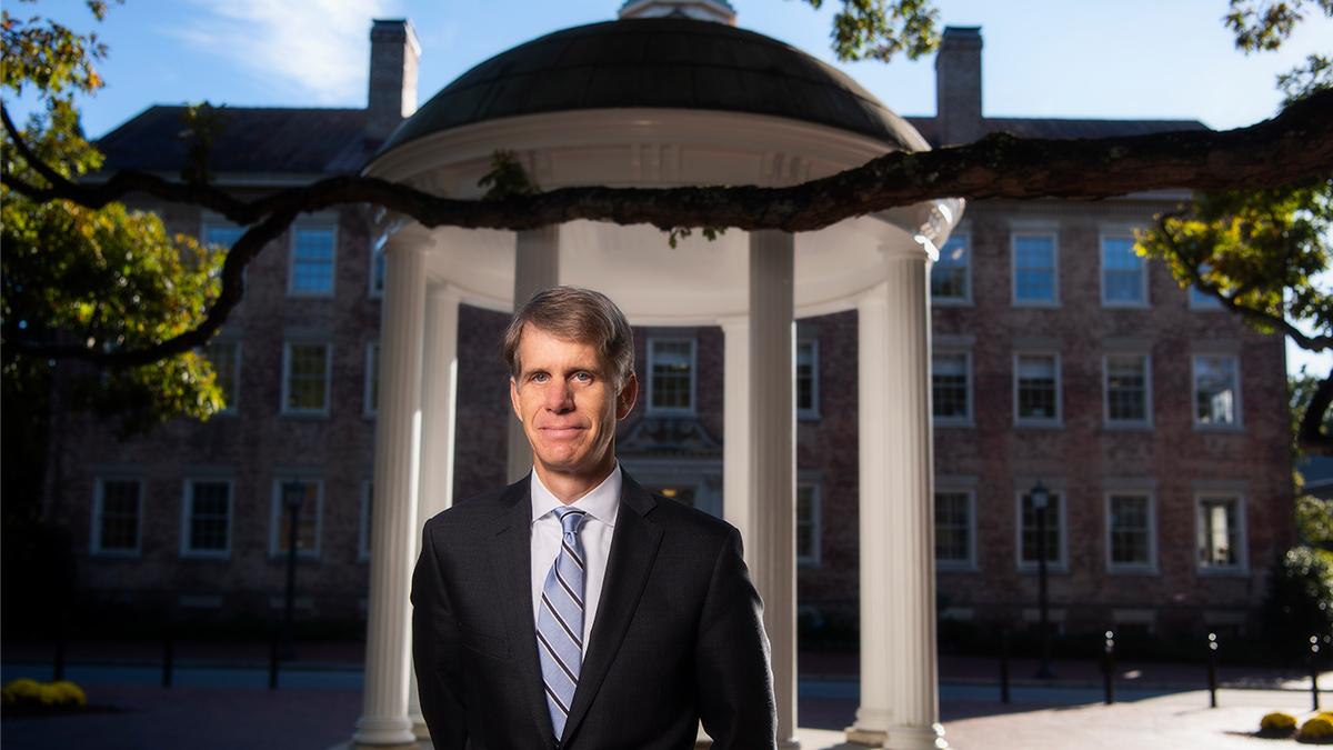 Charles Marshall, Carolina's departing vice chancellor and general counsel, stands in front of the OId Well on a sunny day.